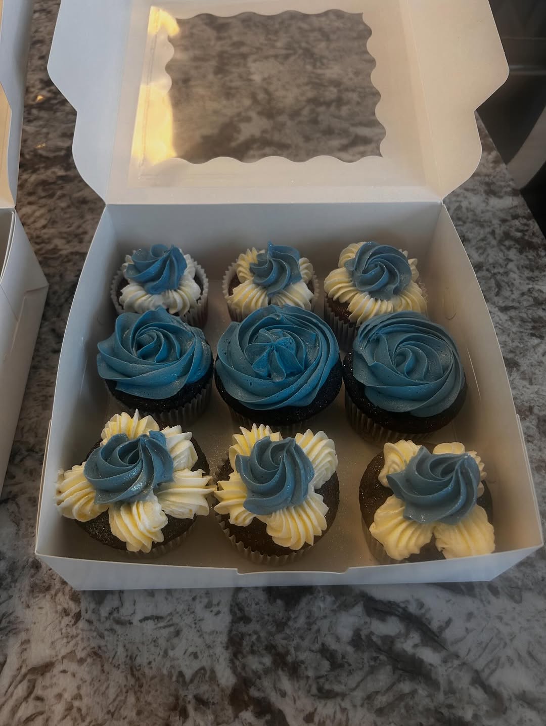 Blue buttercream cupcakes in a gift box