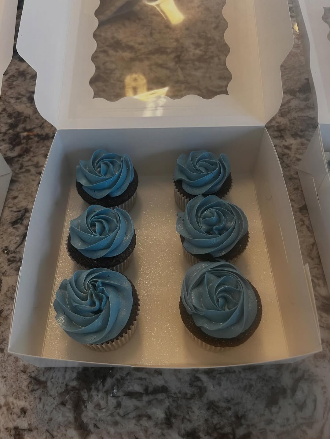 Blue rosette cupcakes in a gift box