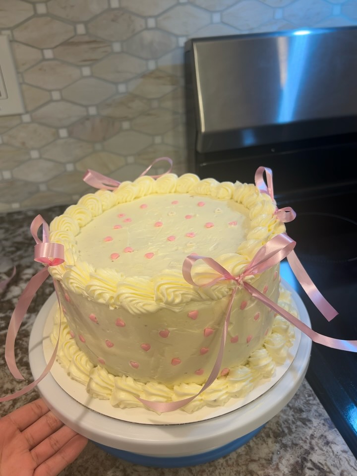 Close view of a custom cake with pink ribbons