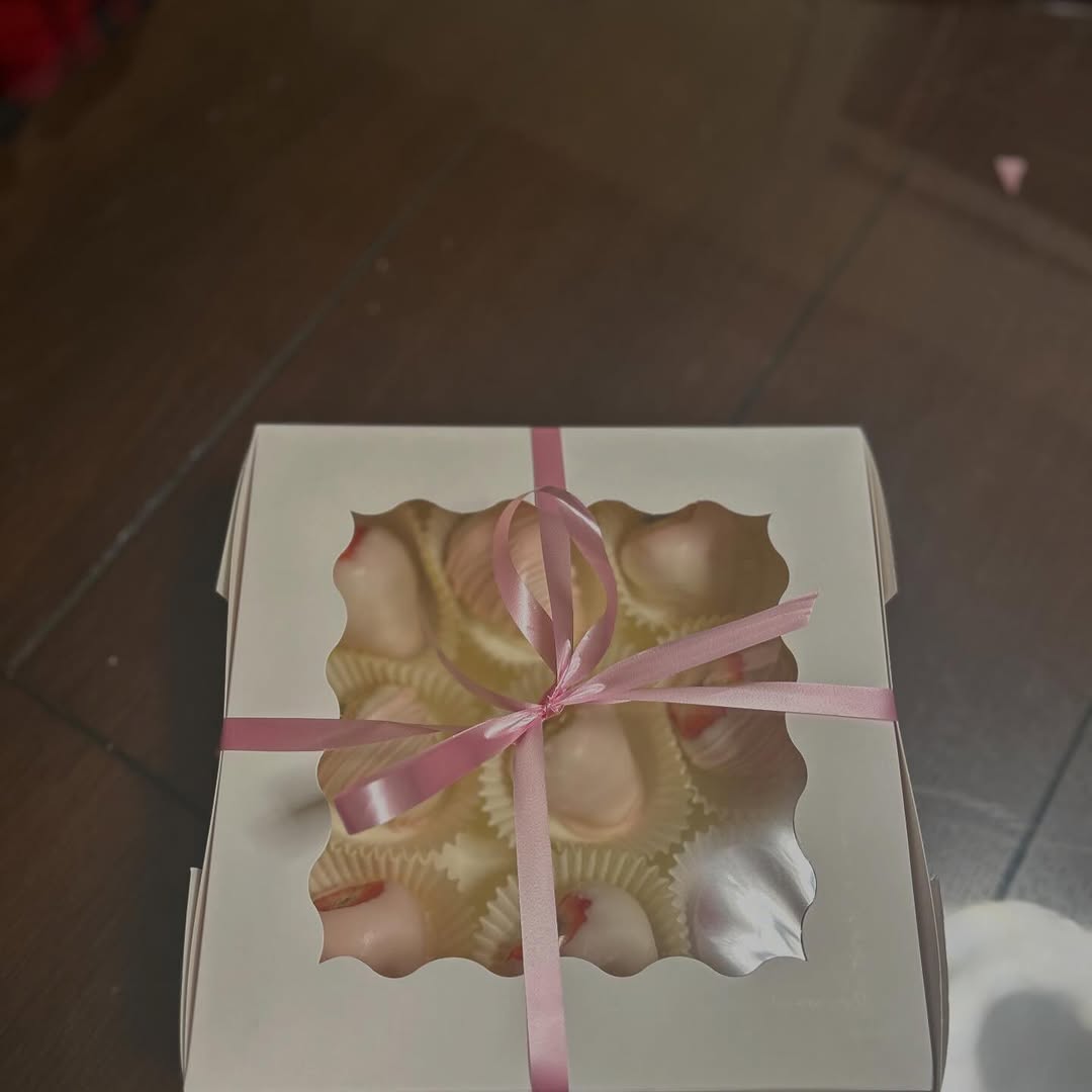 Gift box of decorated strawberries tied with ribbon