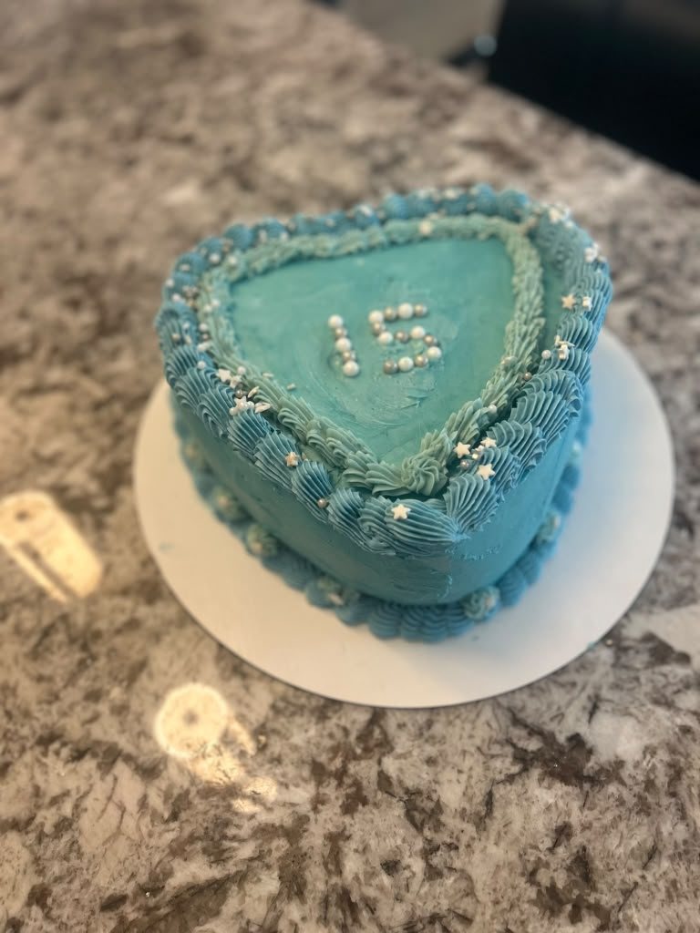 Small blue heart-shaped cake with piped lettering