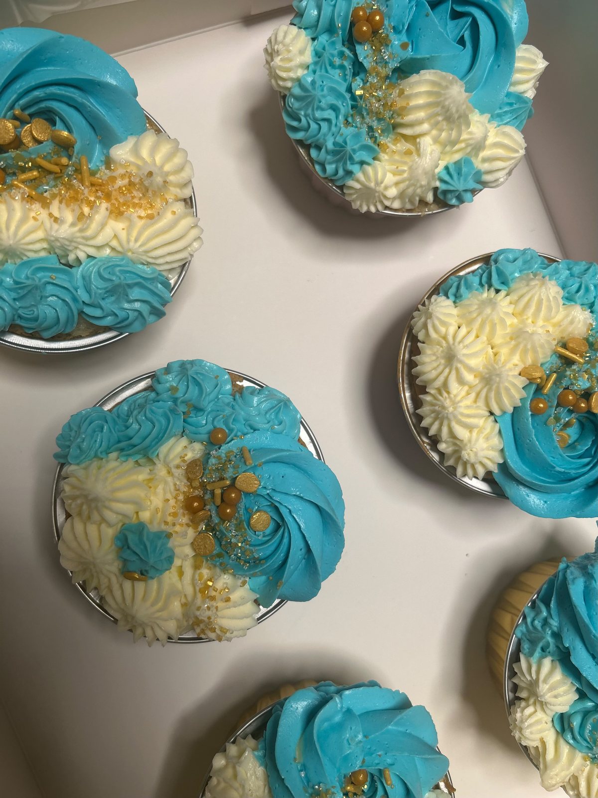 Blue and cream cupcake detail with piped flowers