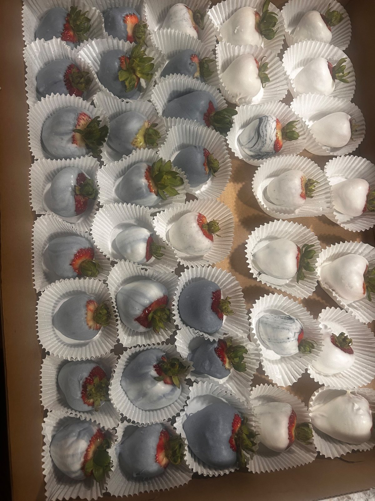White buttercream cupcakes arranged in a box